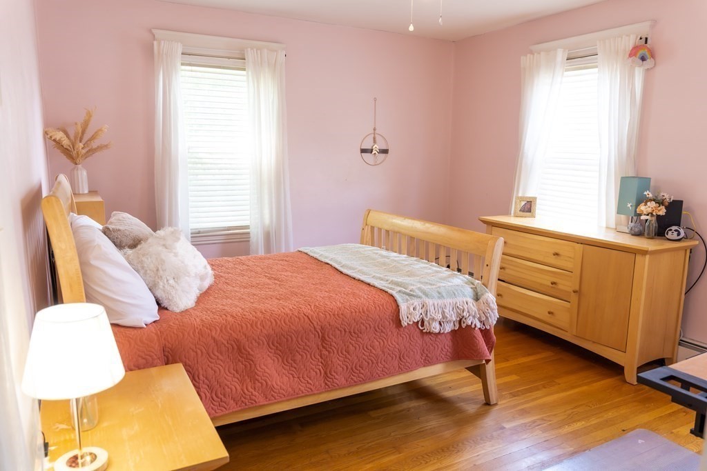 12 Newcastle Road Peabody, MA 01960 - Photo 15 of 35 a bedroom with a bed and wooden floor