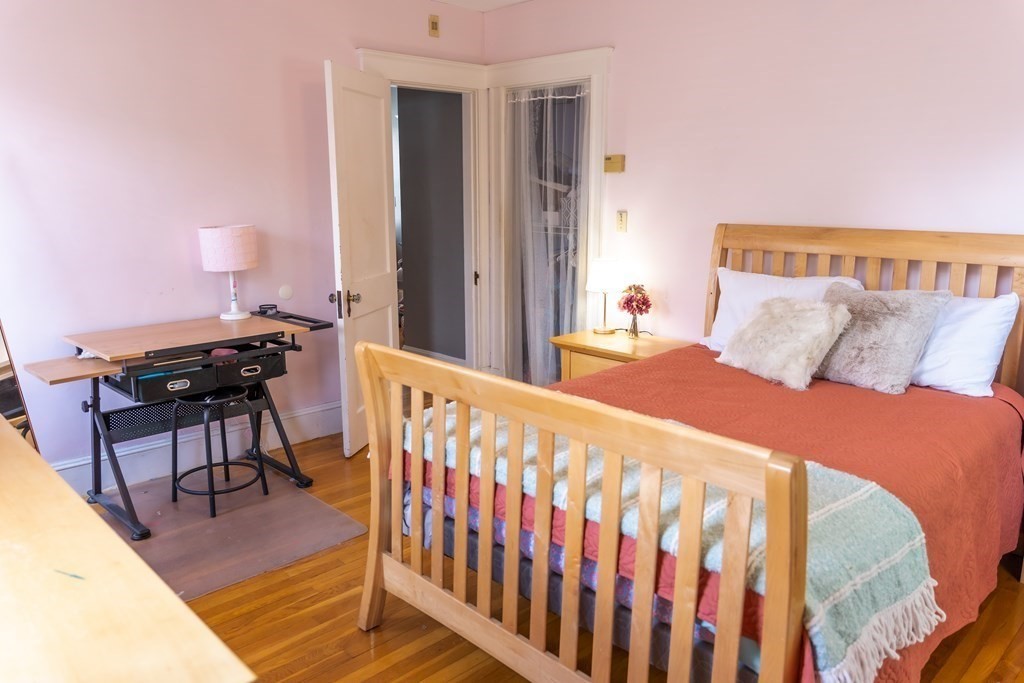 12 Newcastle Road Peabody, MA 01960 - Photo 16 of 35 a bedroom with a bed and wooden floor