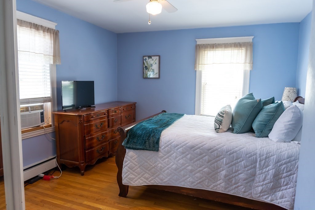 12 Newcastle Road Peabody, MA 01960 - Photo 17 of 35 a bedroom with a bed and a flat tv screen on dresser