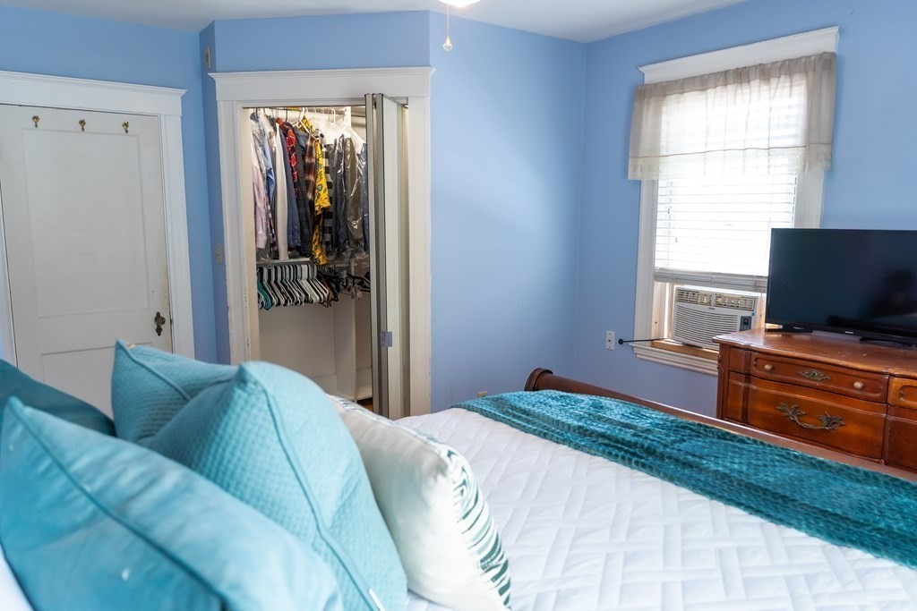 12 Newcastle Road Peabody, MA 01960 - Photo 19 of 35 a bedroom with a bed and flat screen tv