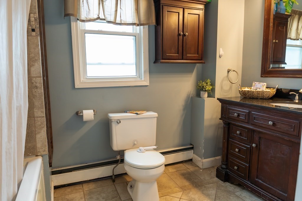 12 Newcastle Road Peabody, MA 01960 - Photo 22 of 35 a bathroom with a toilet sink and mirror