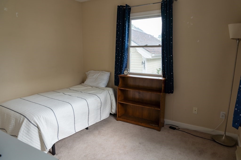 12 Newcastle Road Peabody, MA 01960 - Photo 23 of 35 a bedroom with a bed and a window