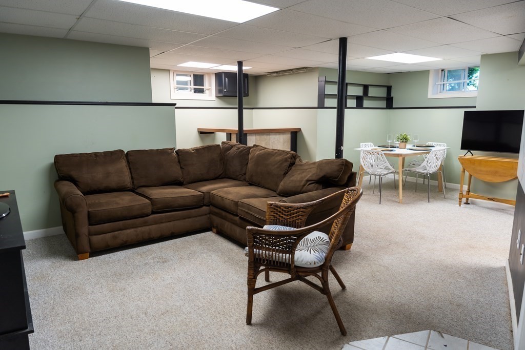 12 Newcastle Road Peabody, MA 01960 - Photo 25 of 35 a living room with furniture and a flat screen tv