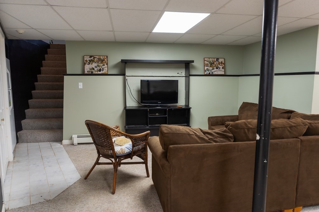 12 Newcastle Road Peabody, MA 01960 - Photo 26 of 35 a living room with furniture and a flat screen tv