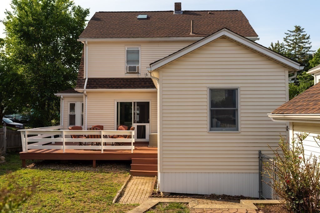 12 Newcastle Road Peabody, MA 01960 - Photo 29 of 35 a view of a white house with a white roof deck and a small yard