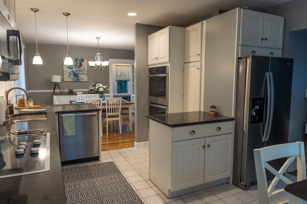 12 Newcastle Road Peabody, MA 01960 - Photo 7 of 35 a kitchen with stainless steel appliances a stove a sink and a refrigerator