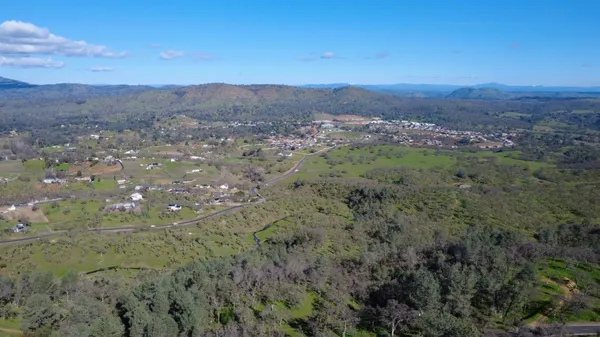 a view of a city with green field