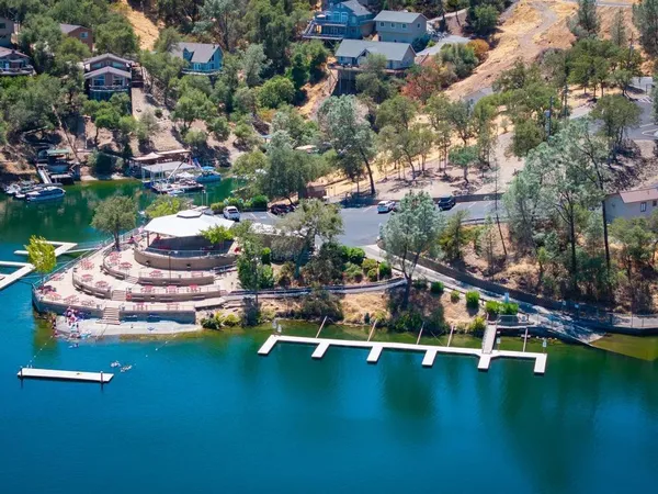 an aerial view of a house with swimming pool outdoor seating and yard