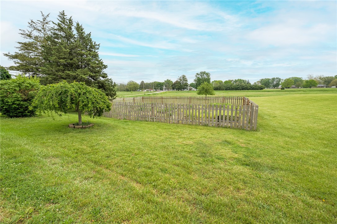 190 Swailes Road Troy, OH 45373 - Photo 68 of 82 Expansive green yard with mature trees and a charming picket fence.