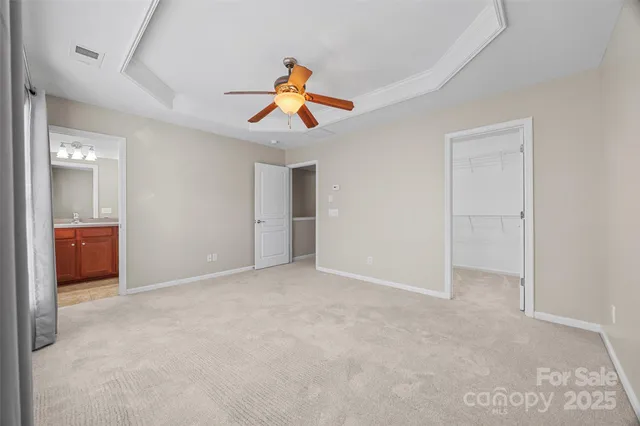 an empty room with windows and cabinet