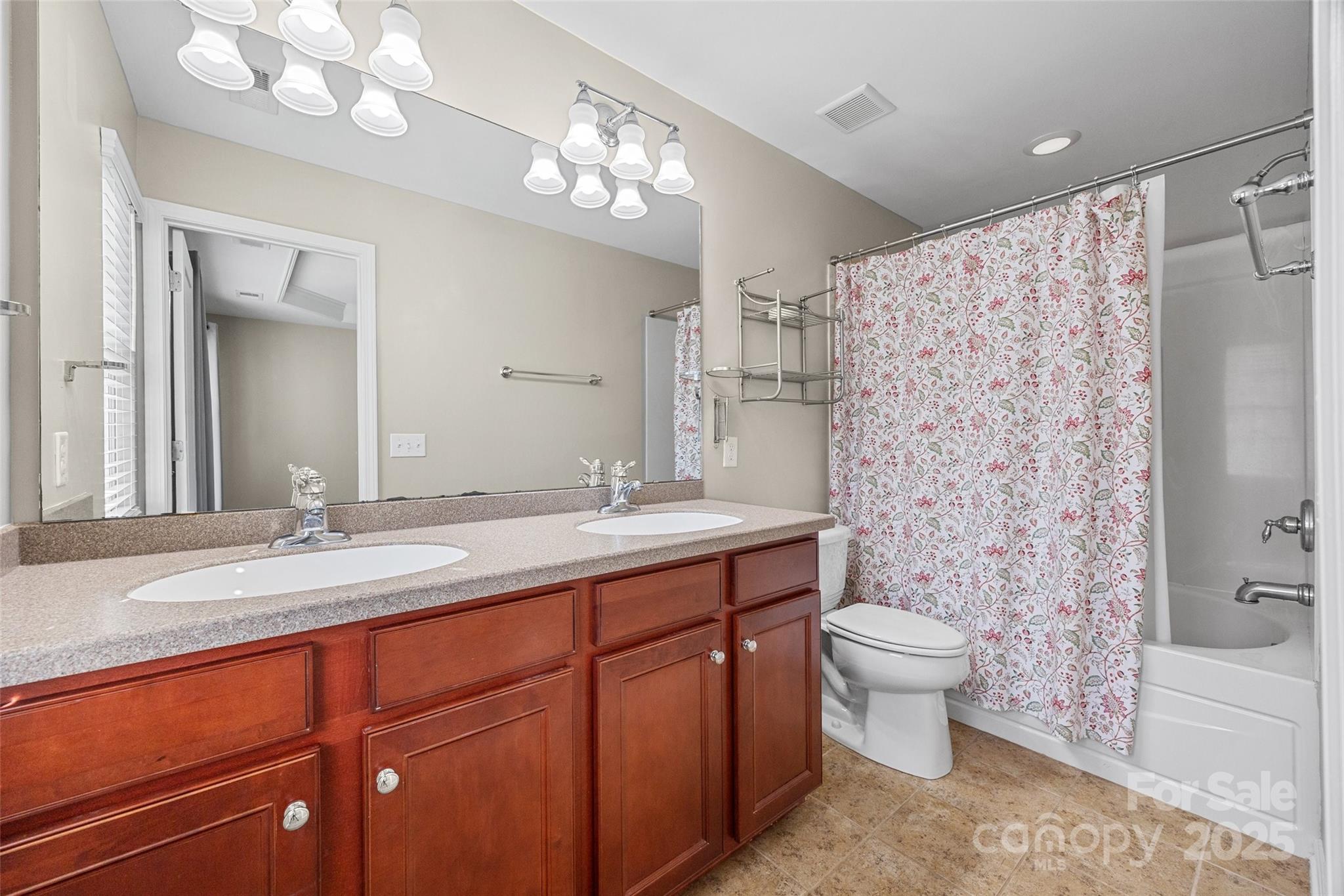 925 Lyndley Drive Fort Mill, SC 29708 - Photo 17 of 24 a spacious bathroom with a double vanity sink mirror and toilet