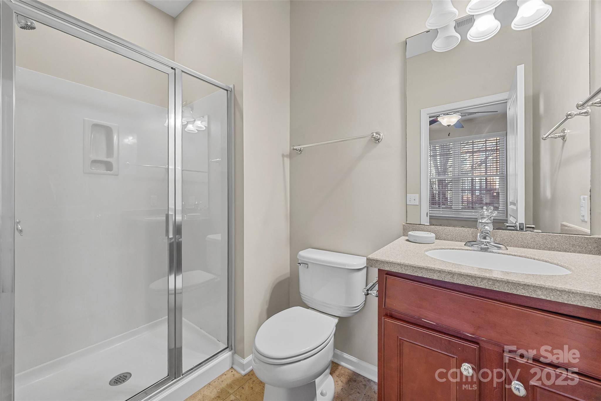 925 Lyndley Drive Fort Mill, SC 29708 - Photo 19 of 24 a bathroom with a granite countertop sink toilet and shower