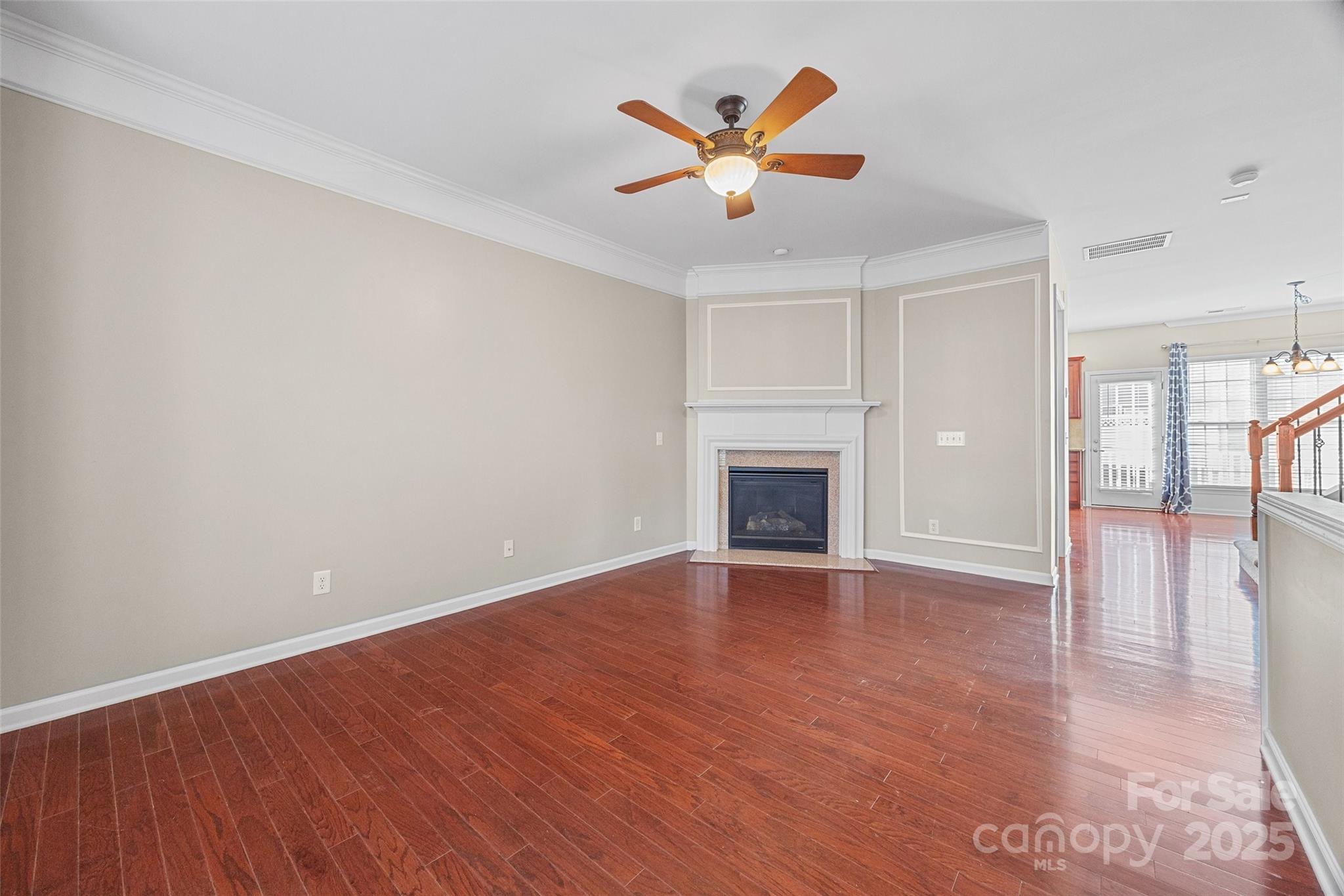 925 Lyndley Drive Fort Mill, SC 29708 - Photo 4 of 24 an empty room with wooden floor and a ceiling fan