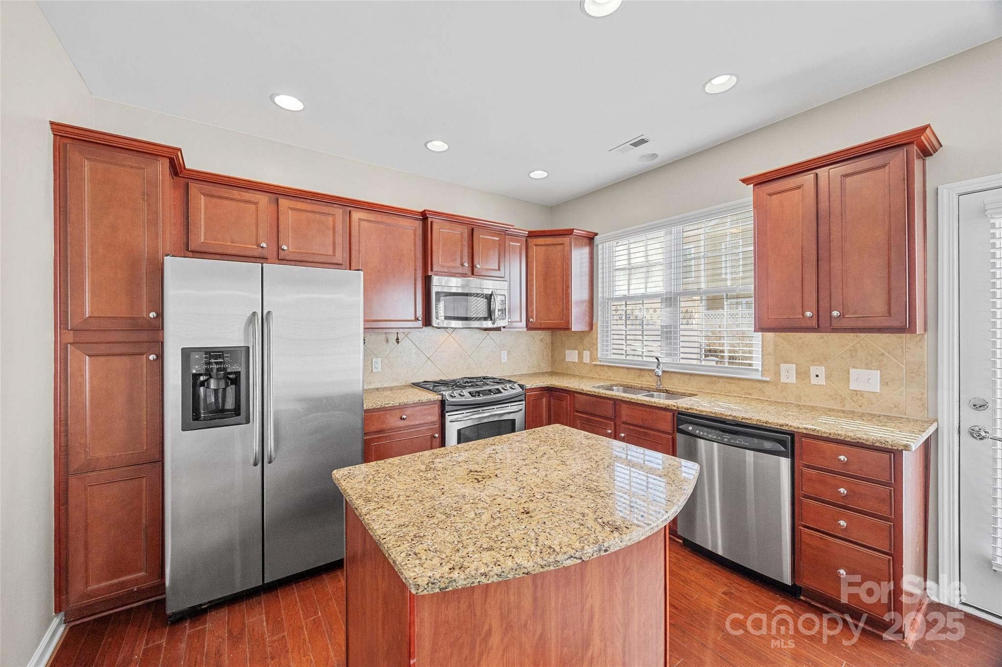 925 Lyndley Drive Fort Mill, SC 29708 - Photo 6 of 24 a kitchen with stainless steel appliances granite countertop refrigerator sink and cabinets
