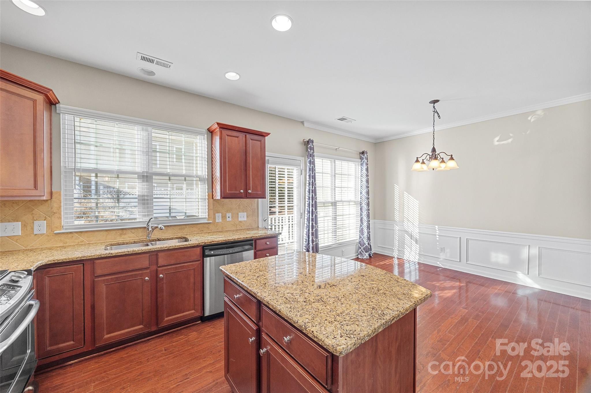 925 Lyndley Drive Fort Mill, SC 29708 - Photo 7 of 24 a kitchen with center island wooden floor and a sink