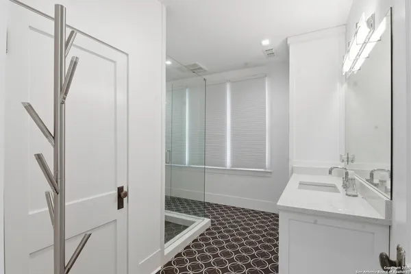 a spacious bathroom with a double vanity sink a mirror and a bathtub