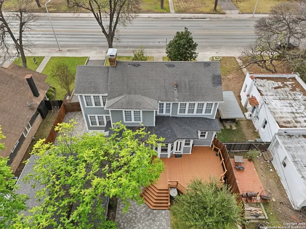 an aerial view of residential houses with outdoor space