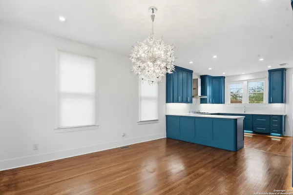 a kitchen with a cabinets and wooden floor