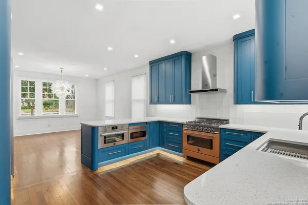 a kitchen with stainless steel appliances granite countertop a refrigerator and a sink