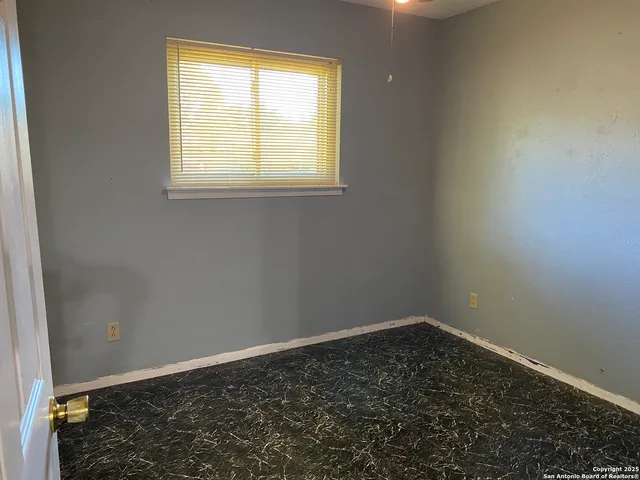 a view of a room with wooden floor and a window