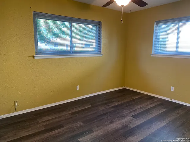 a bathroom with a granite countertop bathtub shower sink vanity and toilet