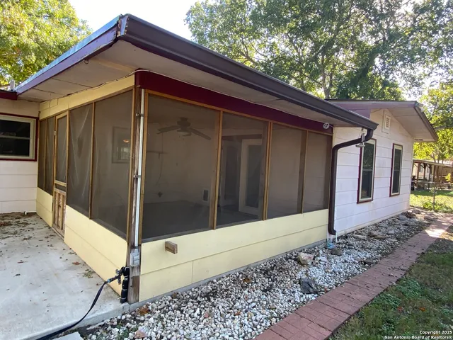 a backyard of a house with barbeque oven and seating space