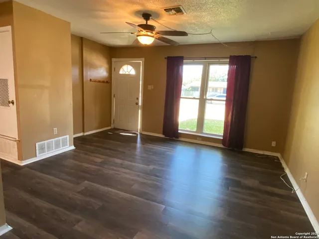 a view of livingroom with hardwood floor and ceiling fan