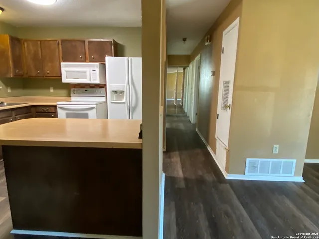 a kitchen with stainless steel appliances a refrigerator sink and stove