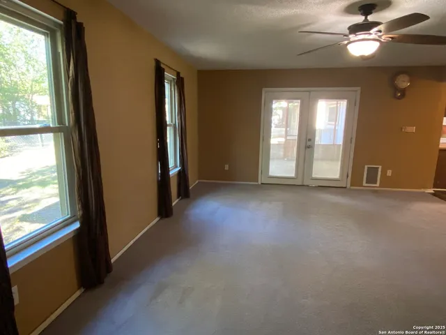 an empty room with a empty space and windows