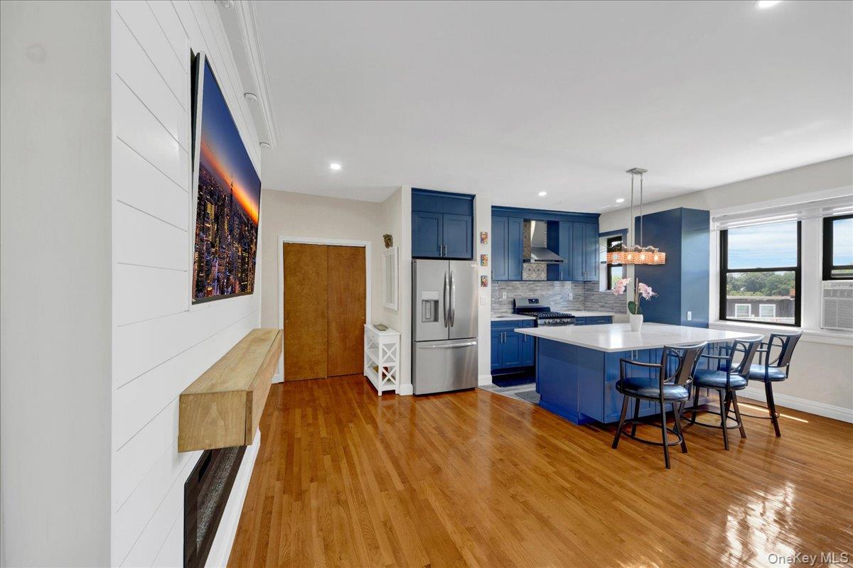 4784 Boston Post Road, Unit B43 Pelham, NY 10803 - Photo 1 of 22 a living room with stainless steel appliances a dining table wooden floor and a window