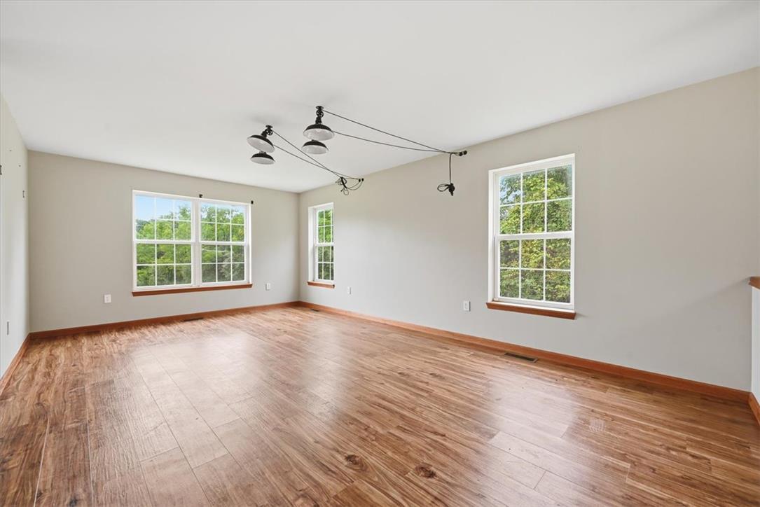387 Blue Ridge Road Saylorsburg, PA 18353 - Photo 34 of 90 Hardwood floors and generous windows illuminate this versatile room, perfect for any living arrangement.
