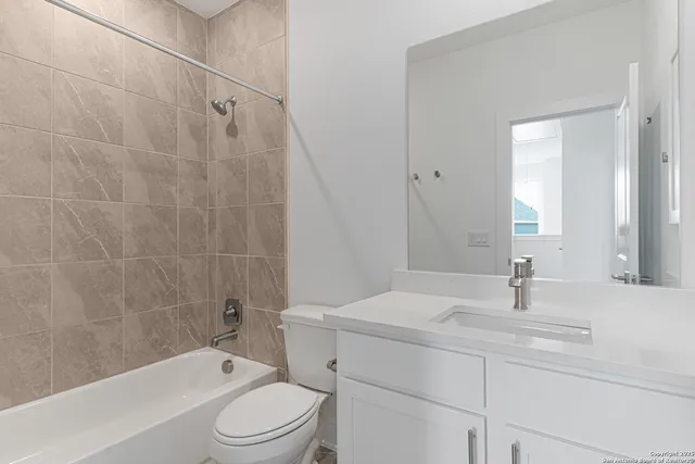 an empty room with a ceiling fan and window