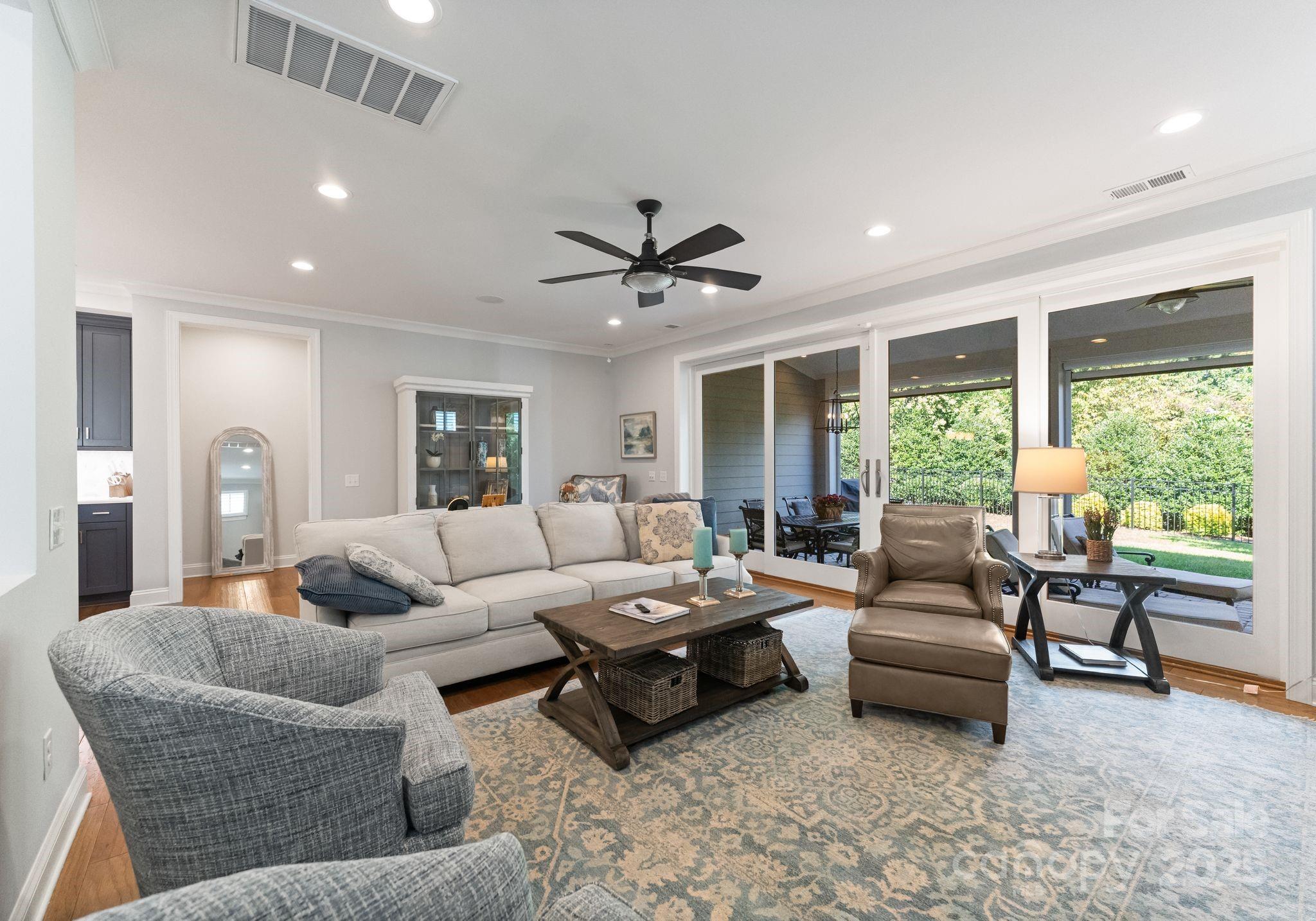 12019 Huntson Reserve Road Huntersville, NC 28078 - Photo 16 of 43 a living room with furniture and a large window with garden view