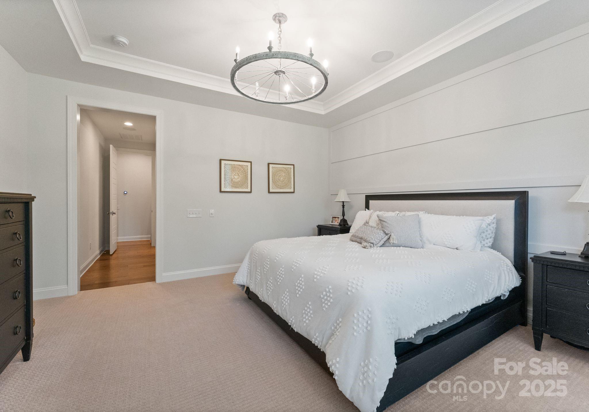 12019 Huntson Reserve Road Huntersville, NC 28078 - Photo 17 of 43 a bedroom with bed and a chandelier