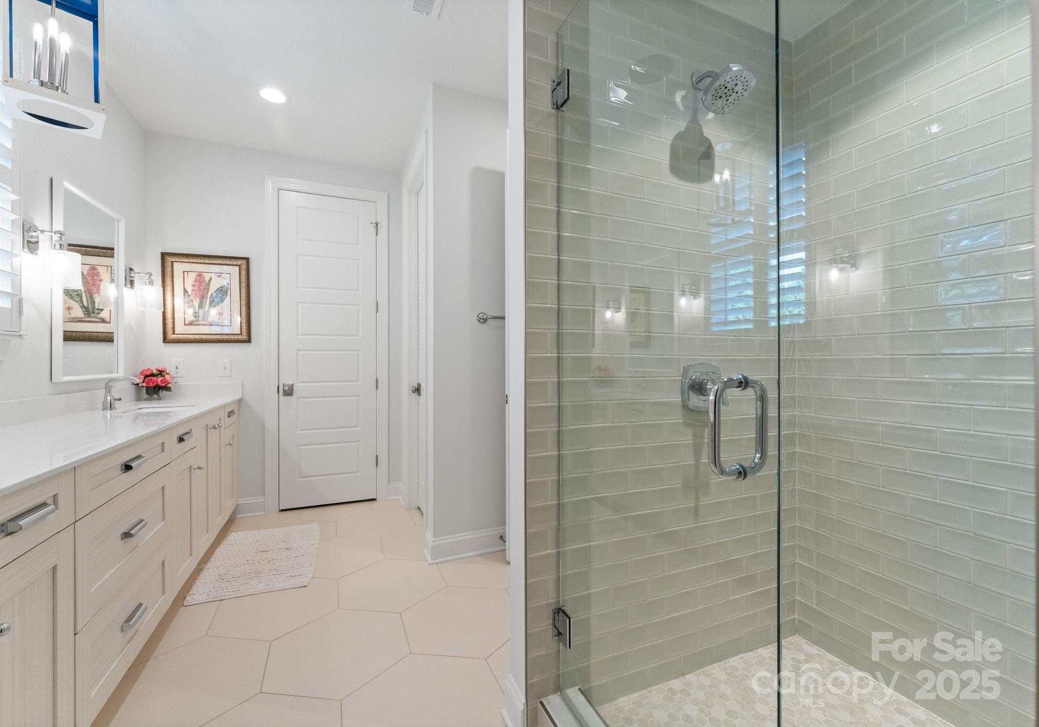 12019 Huntson Reserve Road Huntersville, NC 28078 - Photo 21 of 43 a bathroom with a shower sink and mirror