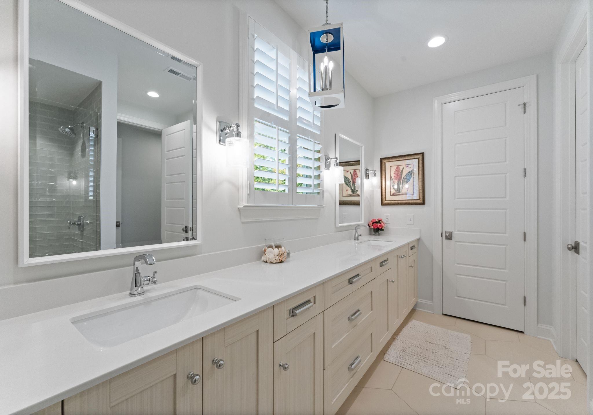 12019 Huntson Reserve Road Huntersville, NC 28078 - Photo 22 of 43 a bathroom with double sink and a mirror