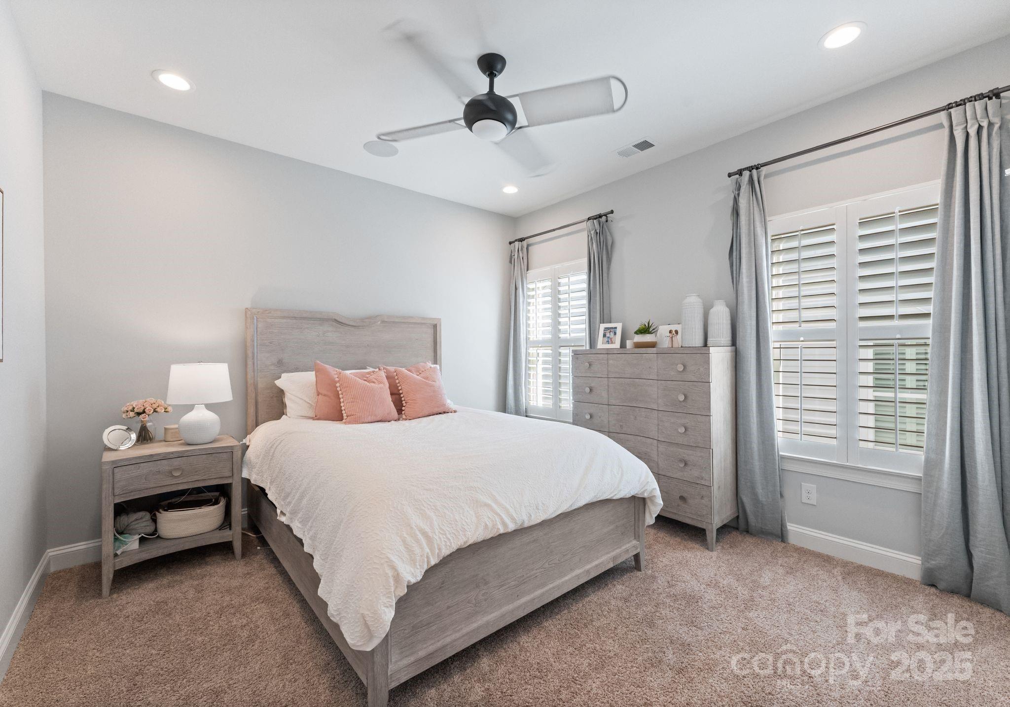 12019 Huntson Reserve Road Huntersville, NC 28078 - Photo 29 of 43 a bedroom with a bed and a chandelier