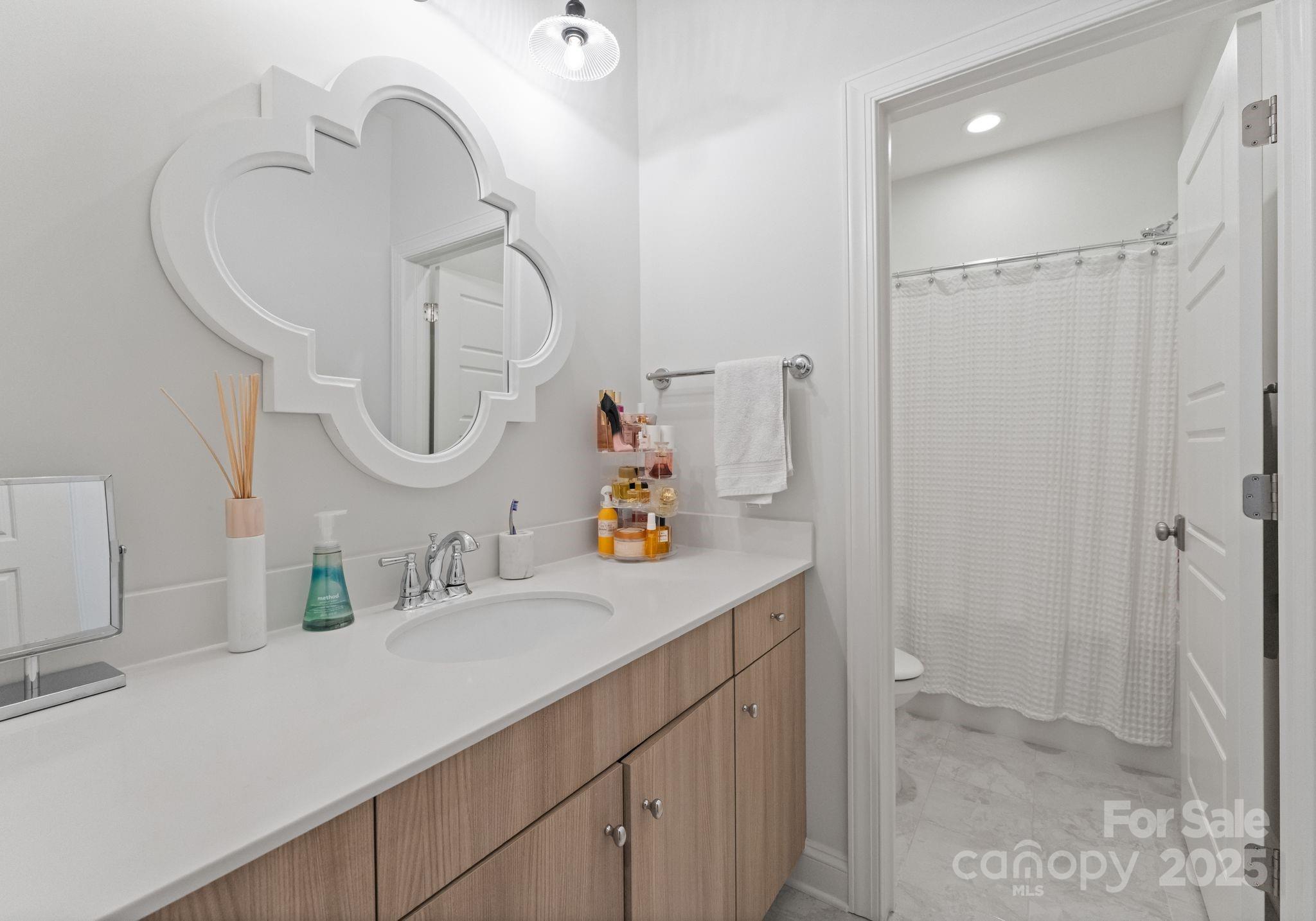12019 Huntson Reserve Road Huntersville, NC 28078 - Photo 30 of 43 a bathroom with a sink vanity and a mirror