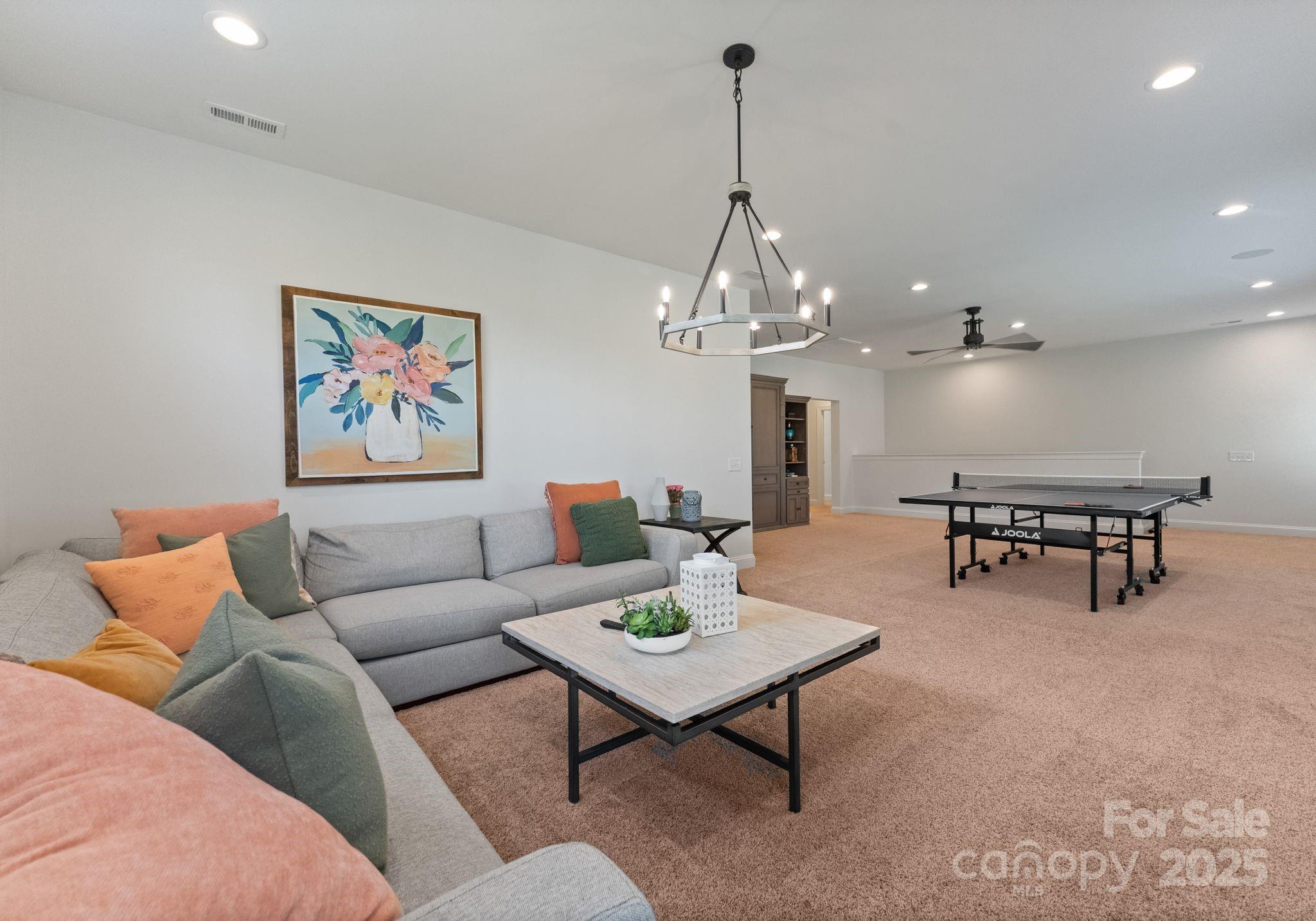 12019 Huntson Reserve Road Huntersville, NC 28078 - Photo 33 of 43 a living room with furniture and a chandelier