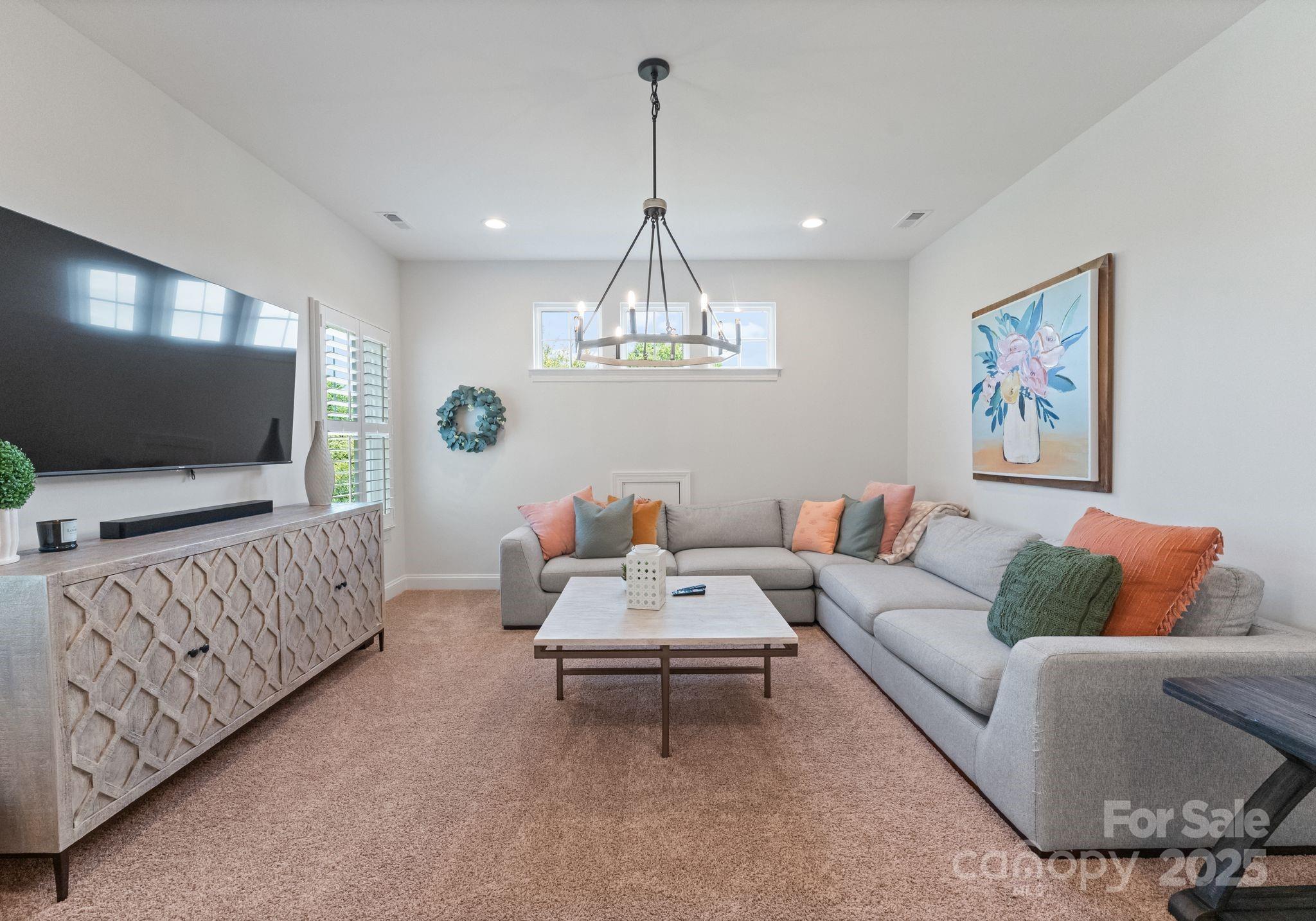 12019 Huntson Reserve Road Huntersville, NC 28078 - Photo 34 of 43 a living room with furniture and a flat screen tv