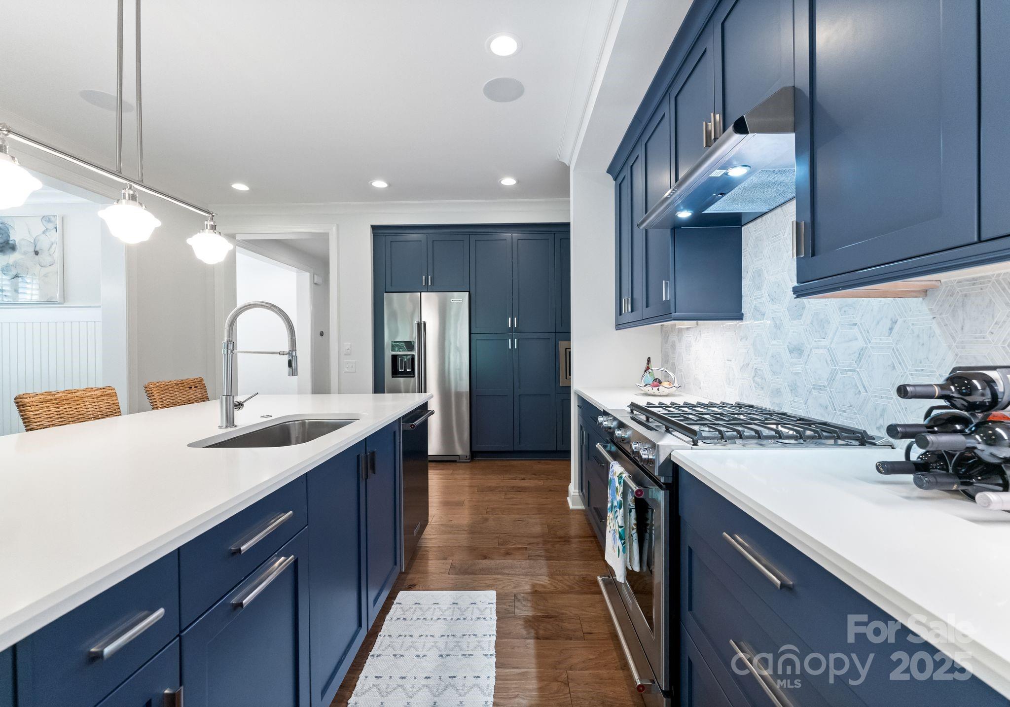 12019 Huntson Reserve Road Huntersville, NC 28078 - Photo 7 of 43 a kitchen with a sink stainless steel appliances and cabinets