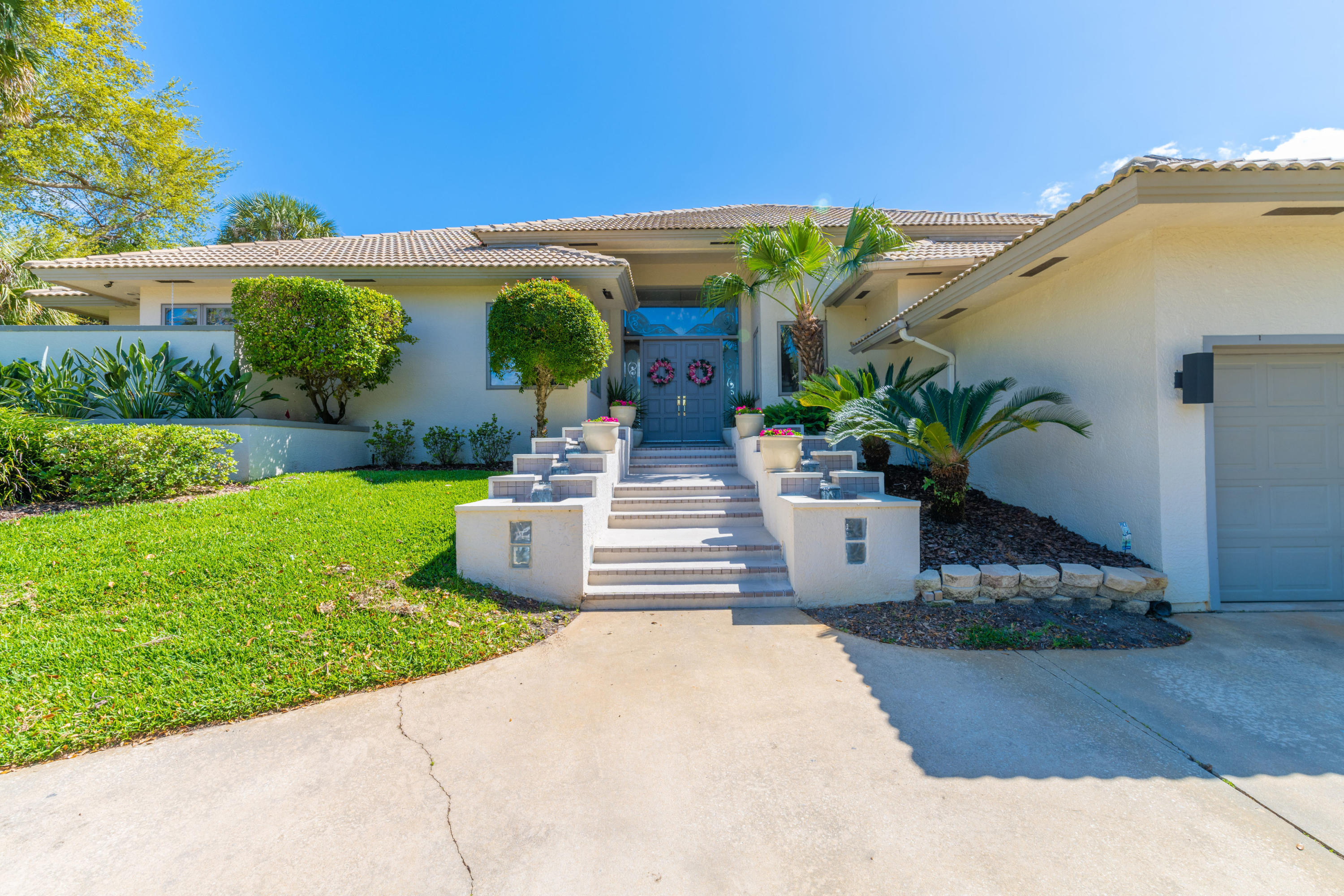 3835 Raney Road Titusville, FL 32780 - Photo 11 of 55 a front view of a house with garden