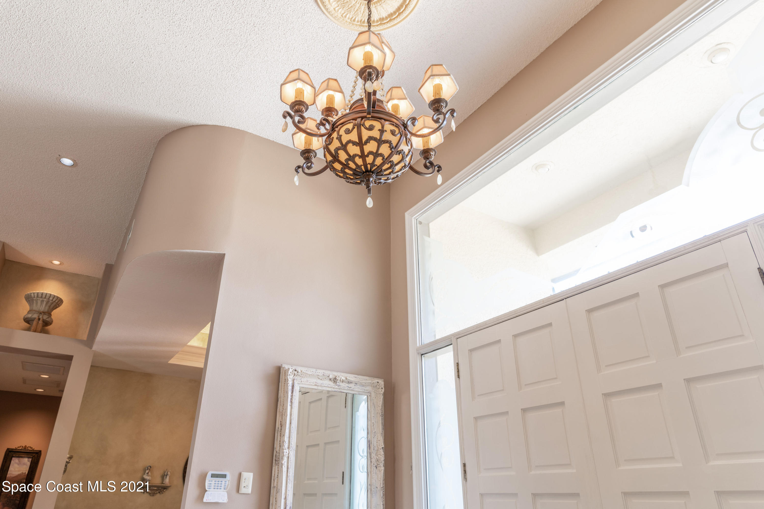 3835 Raney Road Titusville, FL 32780 - Photo 16 of 55 a vase of flowers sitting on a table in front of a window