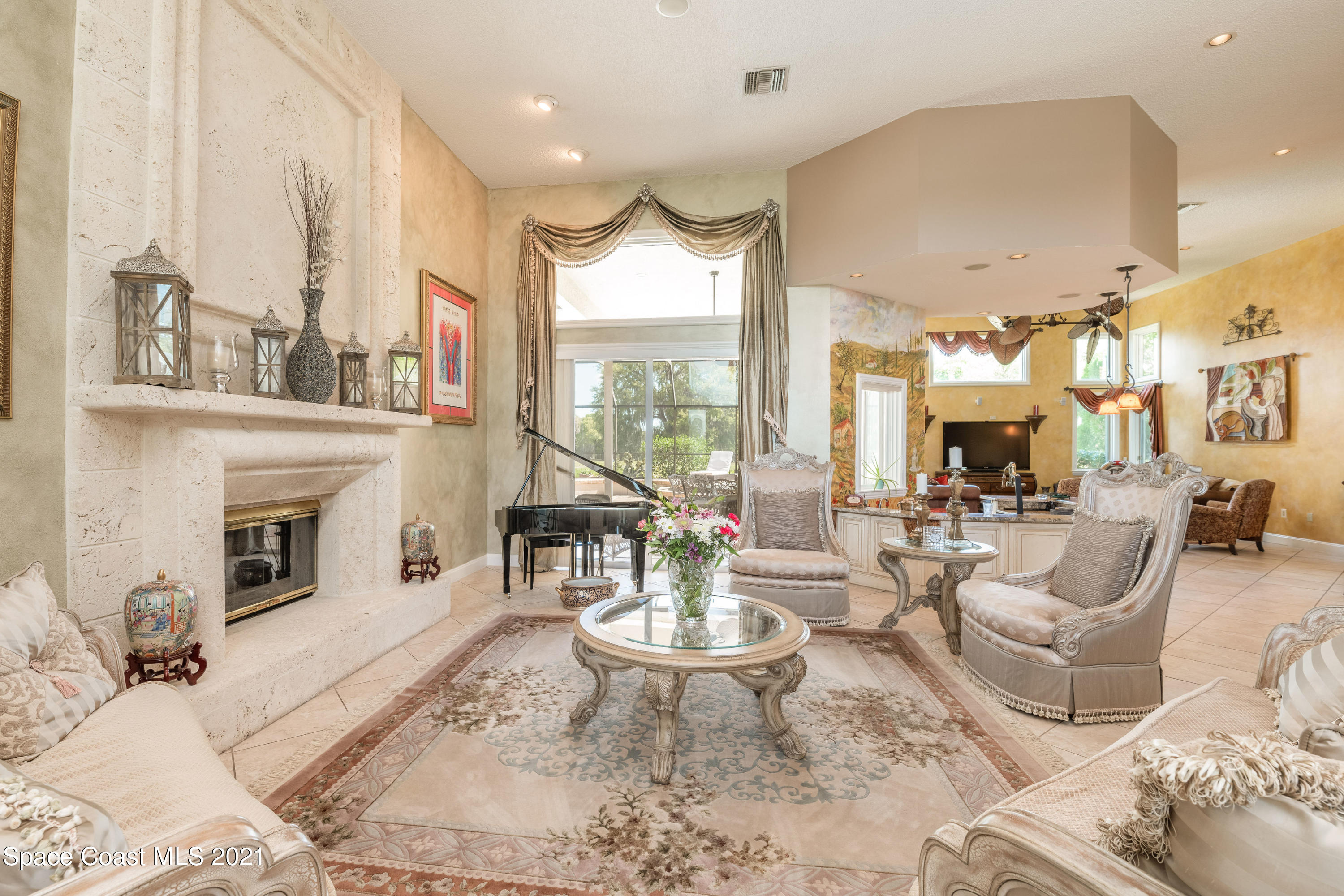 3835 Raney Road Titusville, FL 32780 - Photo 17 of 55 a living room with furniture a fireplace and a large window
