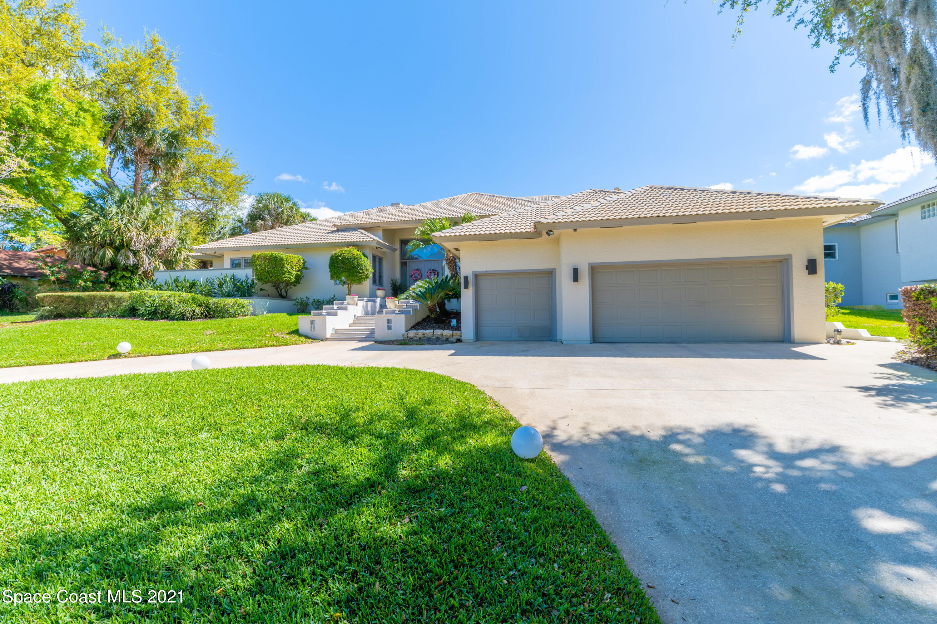 3835 Raney Road Titusville, FL 32780 - Photo 3 of 55 a front view of a house with garden