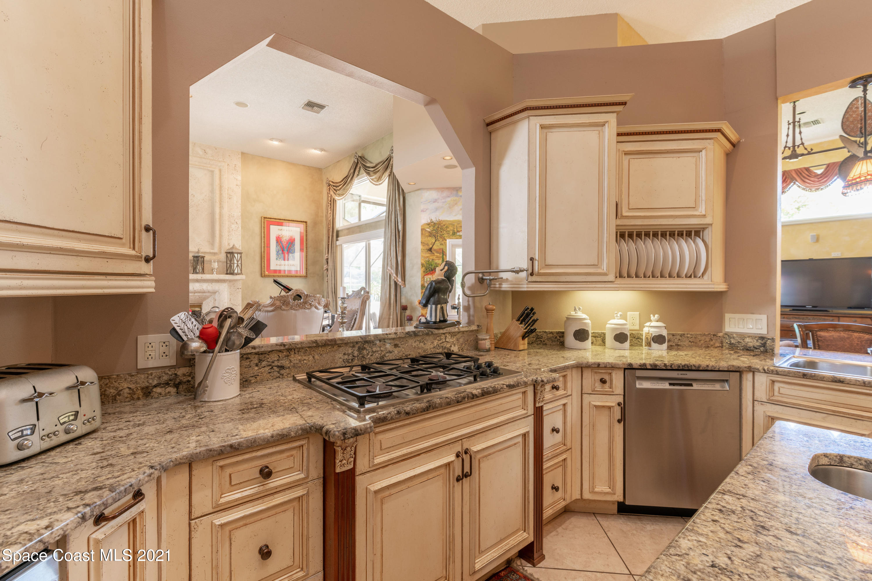 3835 Raney Road Titusville, FL 32780 - Photo 21 of 55 a kitchen with stainless steel appliances granite countertop a stove sink and cabinets