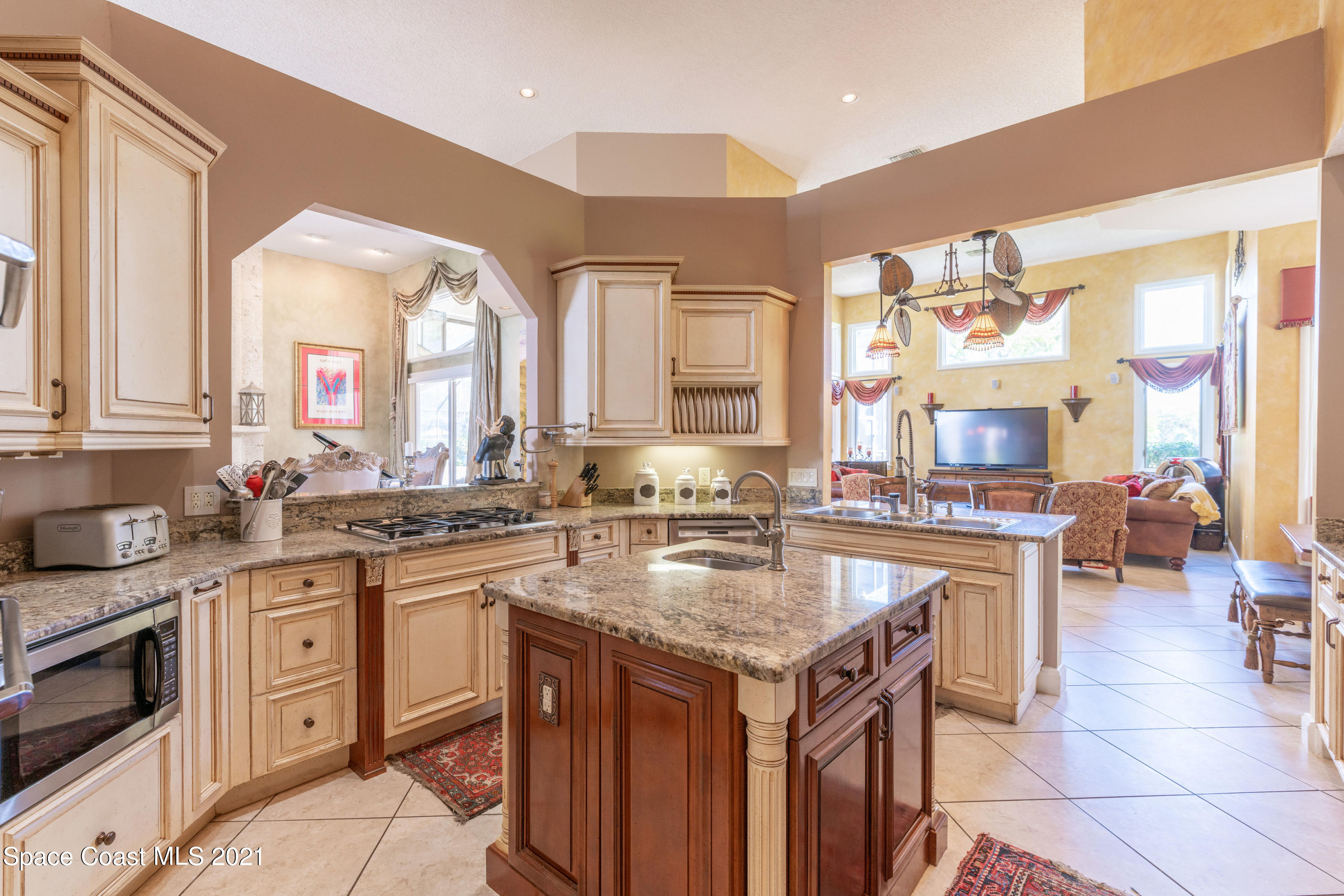 3835 Raney Road Titusville, FL 32780 - Photo 22 of 55 a kitchen with a stove a sink a dining table and chairs