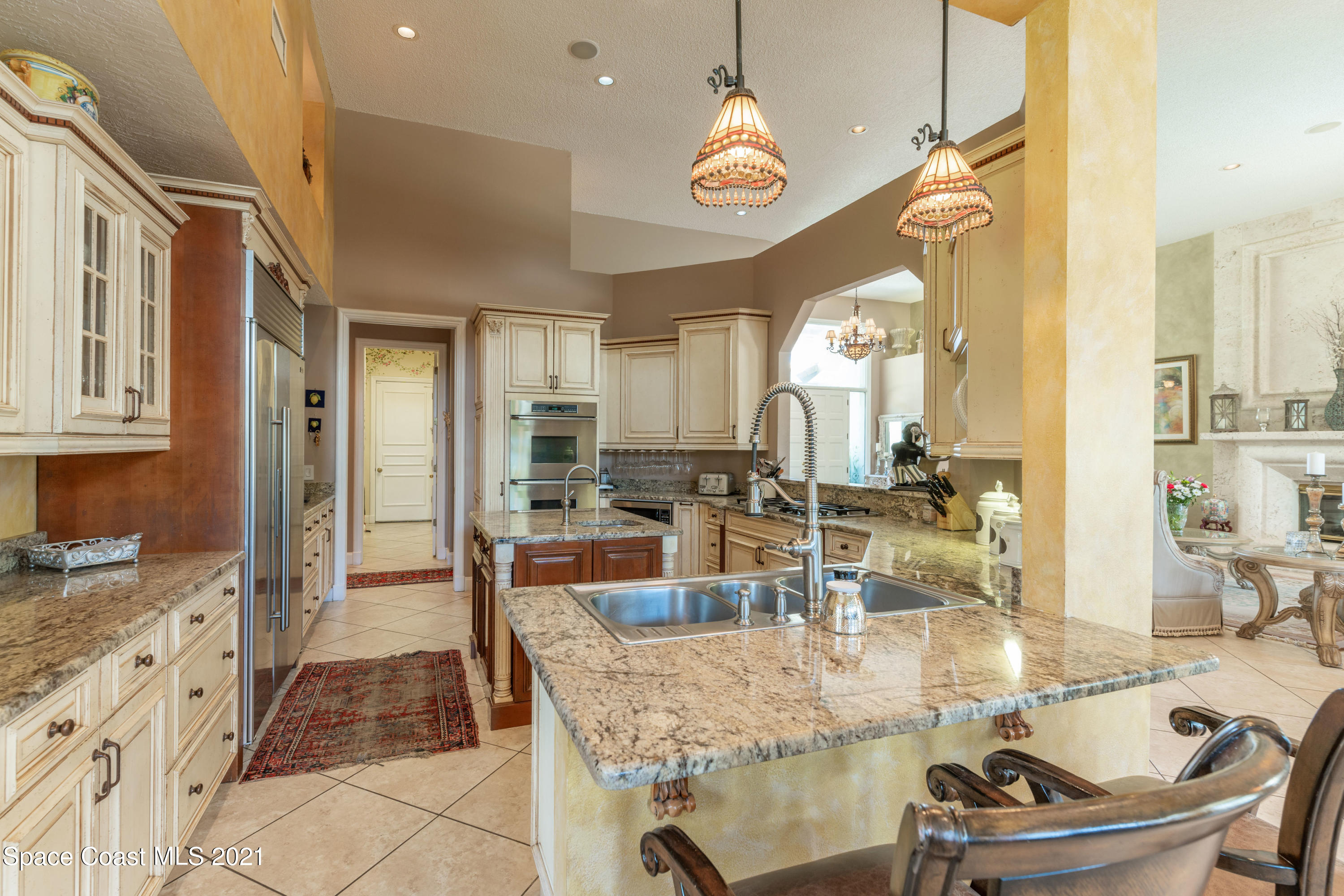3835 Raney Road Titusville, FL 32780 - Photo 24 of 55 a dining hall with stainless steel appliances kitchen island granite countertop a table and chairs