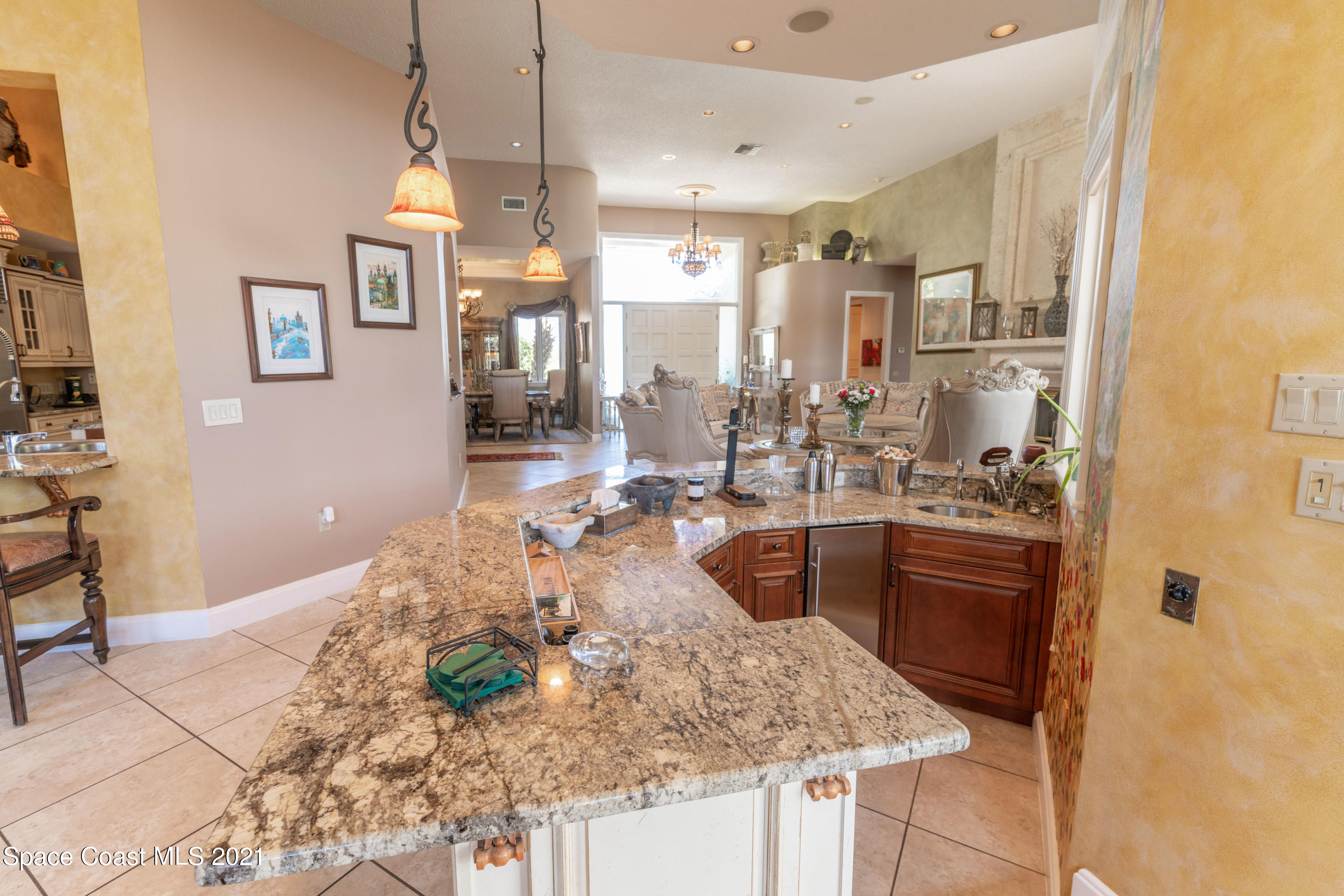 3835 Raney Road Titusville, FL 32780 - Photo 27 of 55 a kitchen with stainless steel appliances granite countertop a sink and a refrigerator