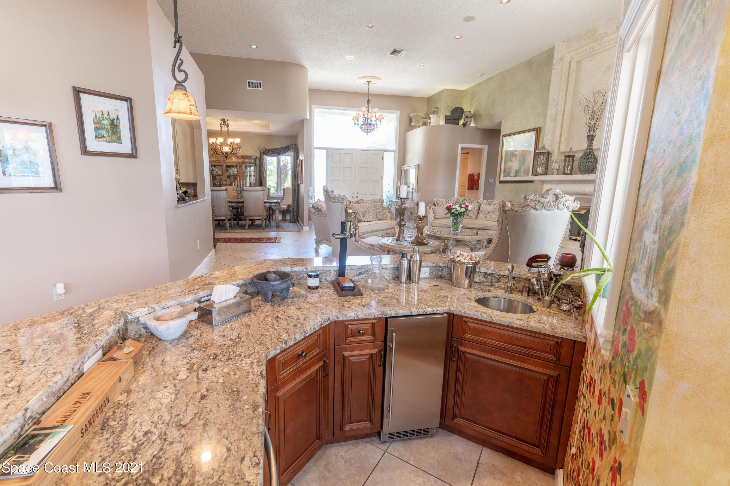 3835 Raney Road Titusville, FL 32780 - Photo 28 of 55 a kitchen with stainless steel appliances granite countertop a sink stove and refrigerator
